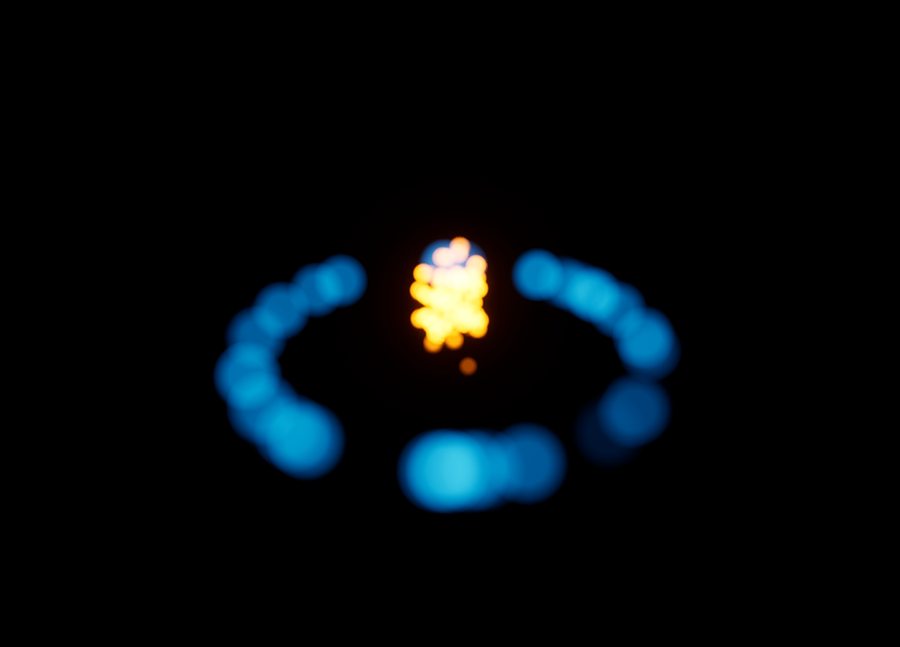 A Niagara effect with a warm orange core and a ring of cyan halo particles